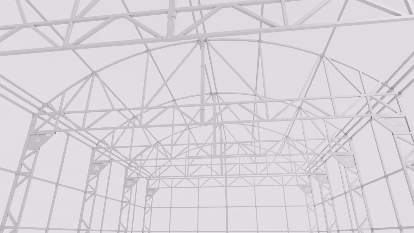 Inside the greenhouse frame — open truss, no interior posts shading the crop